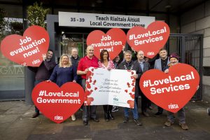 Local authority staff back industrial action . Staff outside the LGMA holding posters of love hearts, with the words job evaluation and love local government.