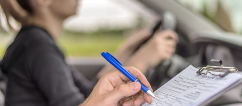Image of driving test with driver and tester in car, test only in vehicles with valid NCT