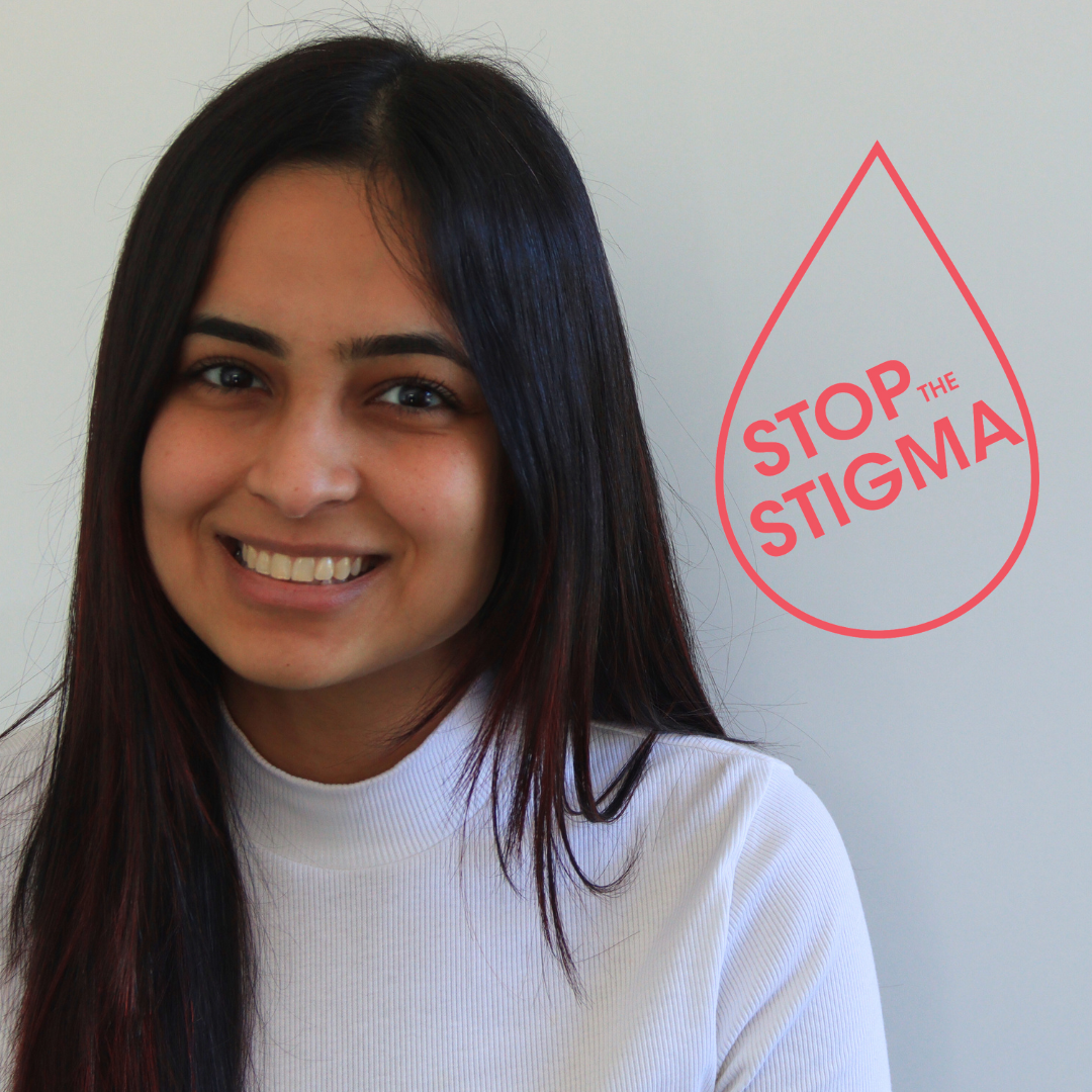 A woman smiling at the camera, representing periods and menopause workplace resources