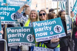 School secretaries at Leinster House rally holding Pension Parity now placards