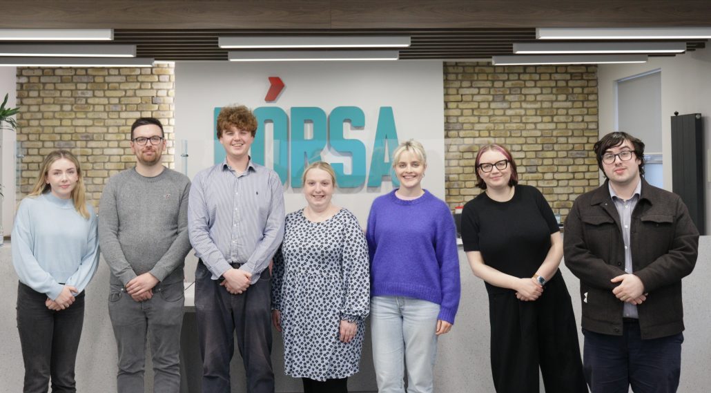 The 7 members of the F&oacute;rsa Youth leadership team stand together in the lobby of F&oacute;rsa's head office.